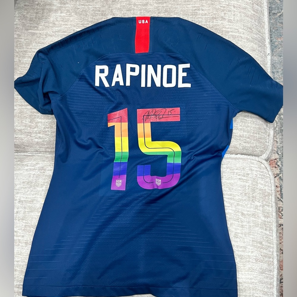 World Cup soccer jersey, cleats and magazine signed Megan Rapinoe